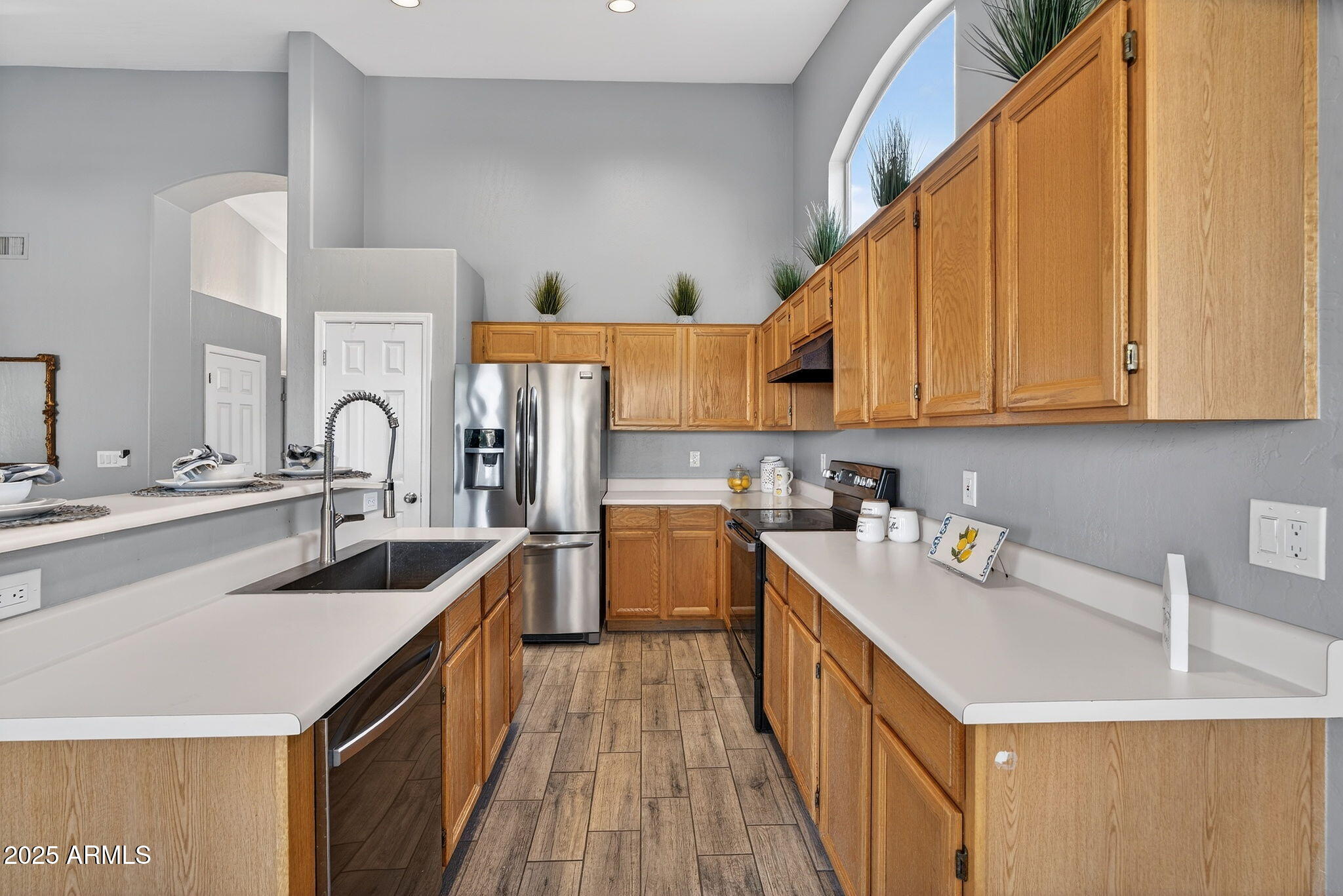 15427 South 16th Avenue Phoenix, AZ 85045 - Photo 6 of 53 a kitchen with a sink stove and cabinets