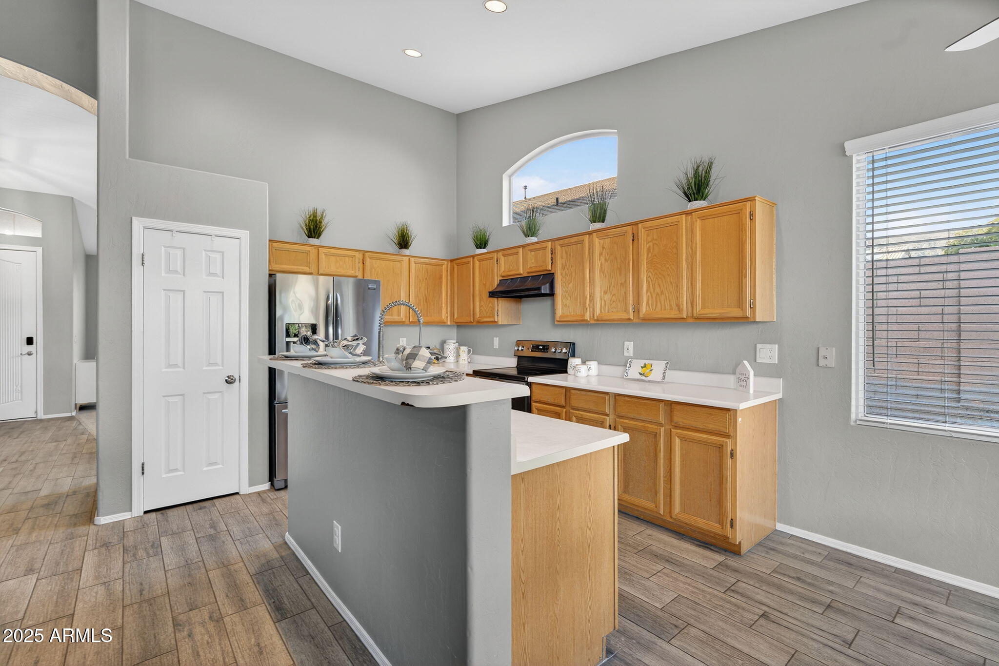 15427 South 16th Avenue Phoenix, AZ 85045 - Photo 7 of 53 a kitchen with stainless steel appliances granite countertop a sink stove and refrigerator