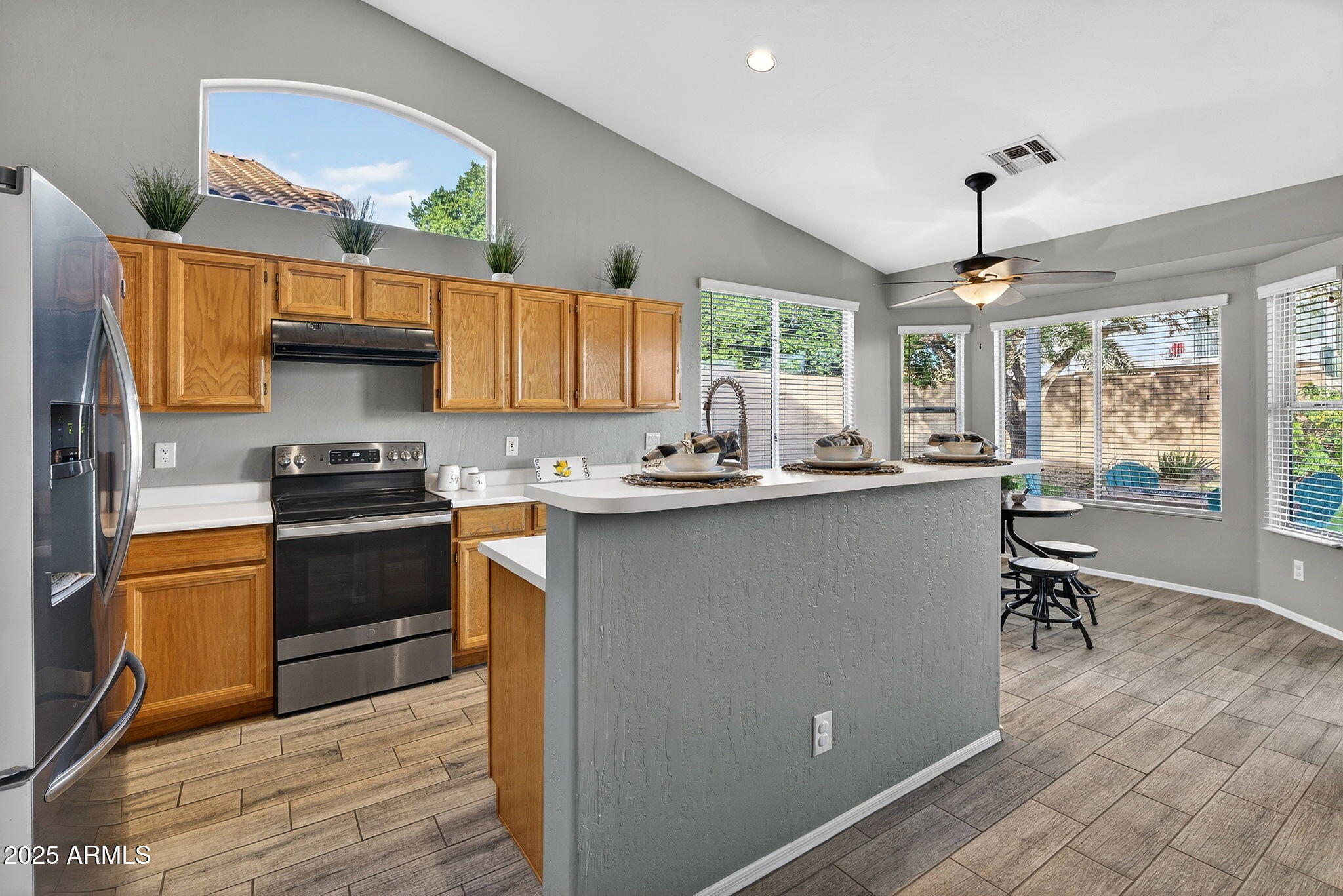 15427 South 16th Avenue Phoenix, AZ 85045 - Photo 8 of 53 a kitchen with granite countertop a stove a sink a dining table and chairs