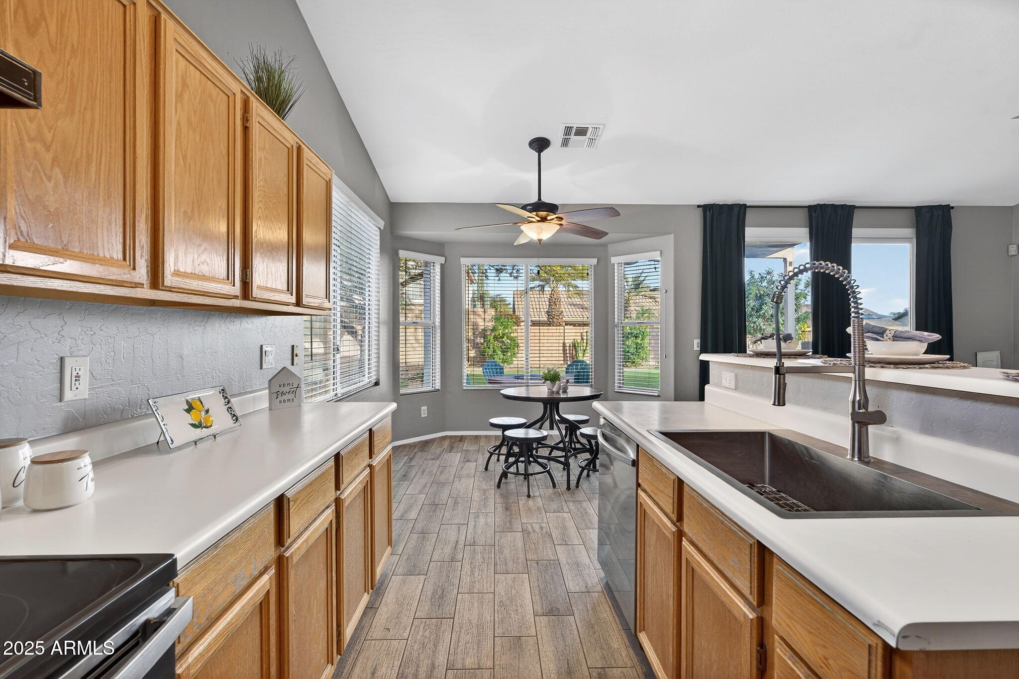 15427 South 16th Avenue Phoenix, AZ 85045 - Photo 9 of 53 a kitchen with sink cabinets and dining table