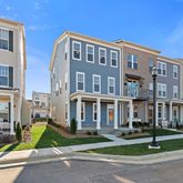 a front view of a residential apartment building with a yard