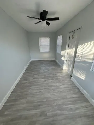 a view of an empty room and wooden floor