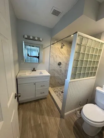 a bathroom with a sink toilet and shower