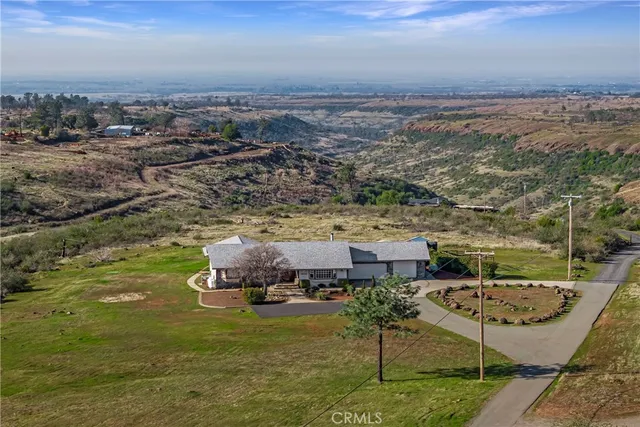an aerial view of a house with a yard