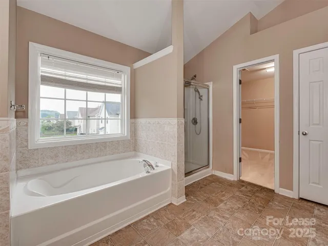 a bathroom with a bathtub and shower