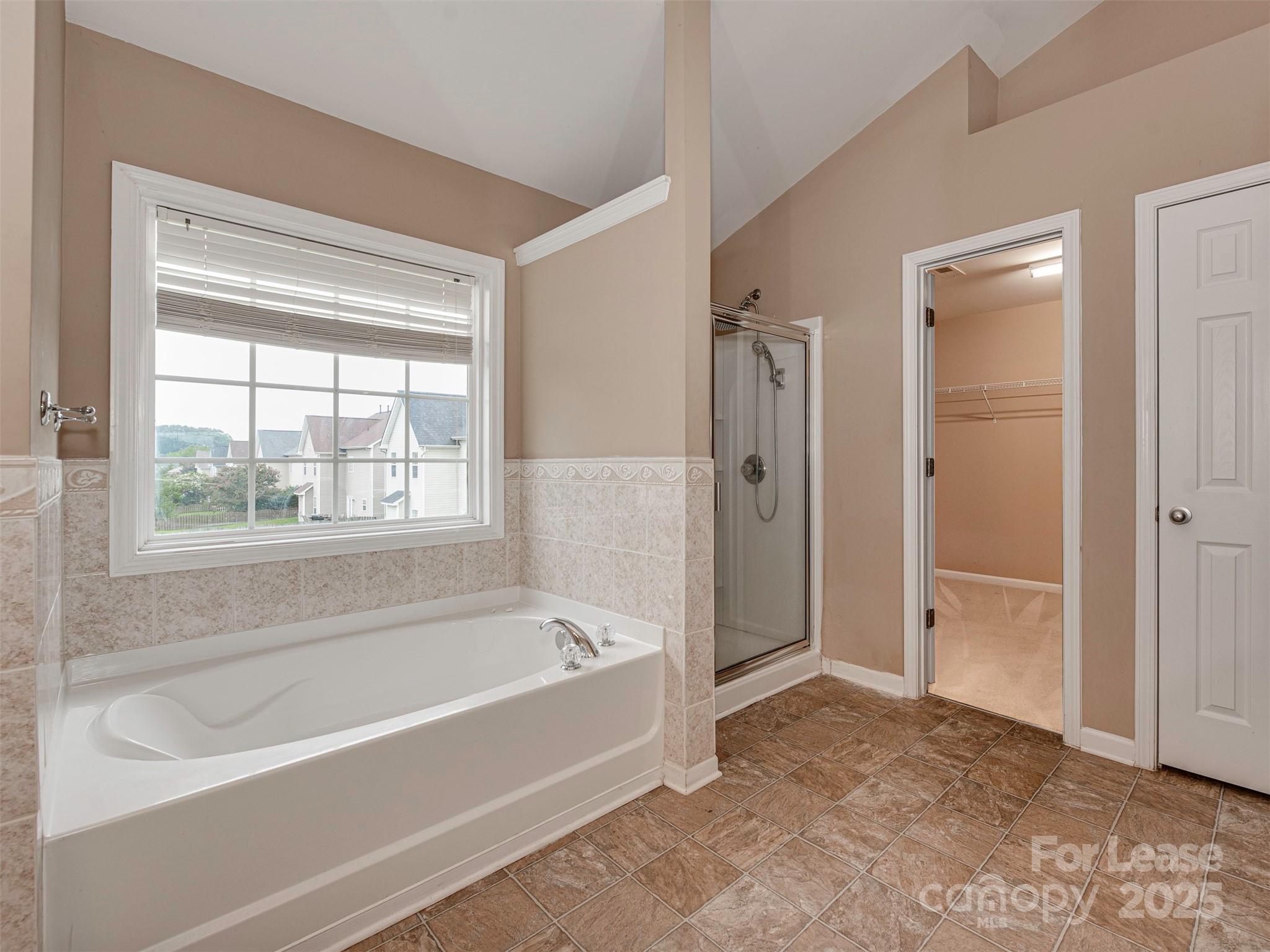 5607 Fulton Ridge Drive Indian Trail, NC 28079 - Photo 19 of 27 a bathroom with a bathtub and shower