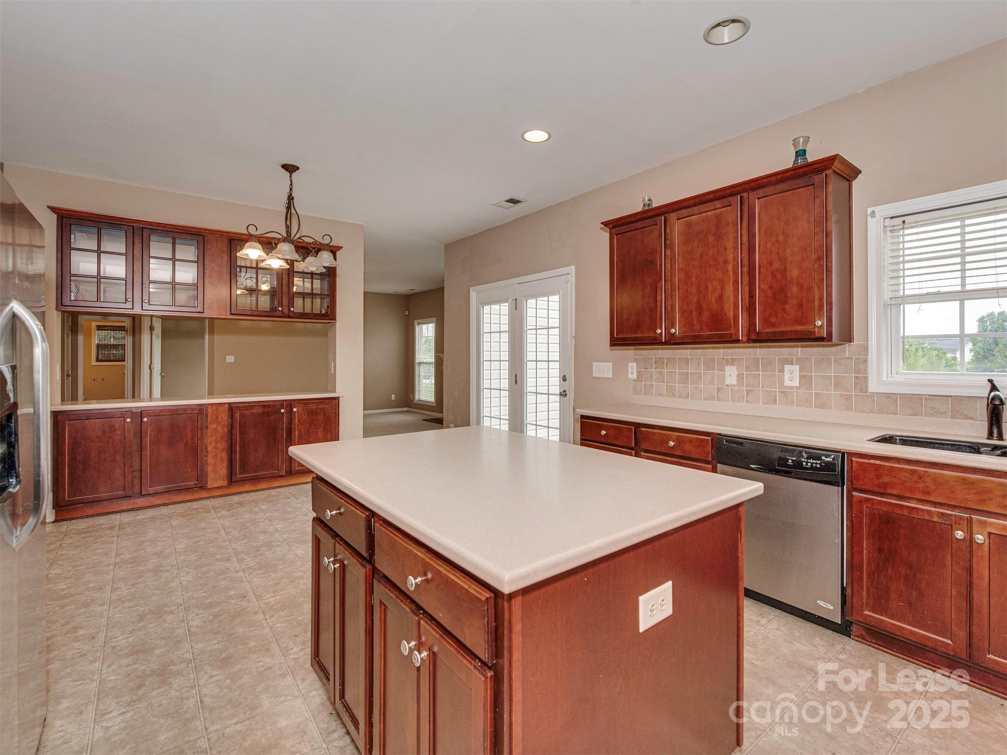 5607 Fulton Ridge Drive Indian Trail, NC 28079 - Photo 7 of 27 a kitchen that has a sink a microwave oven a stove and white cabinets