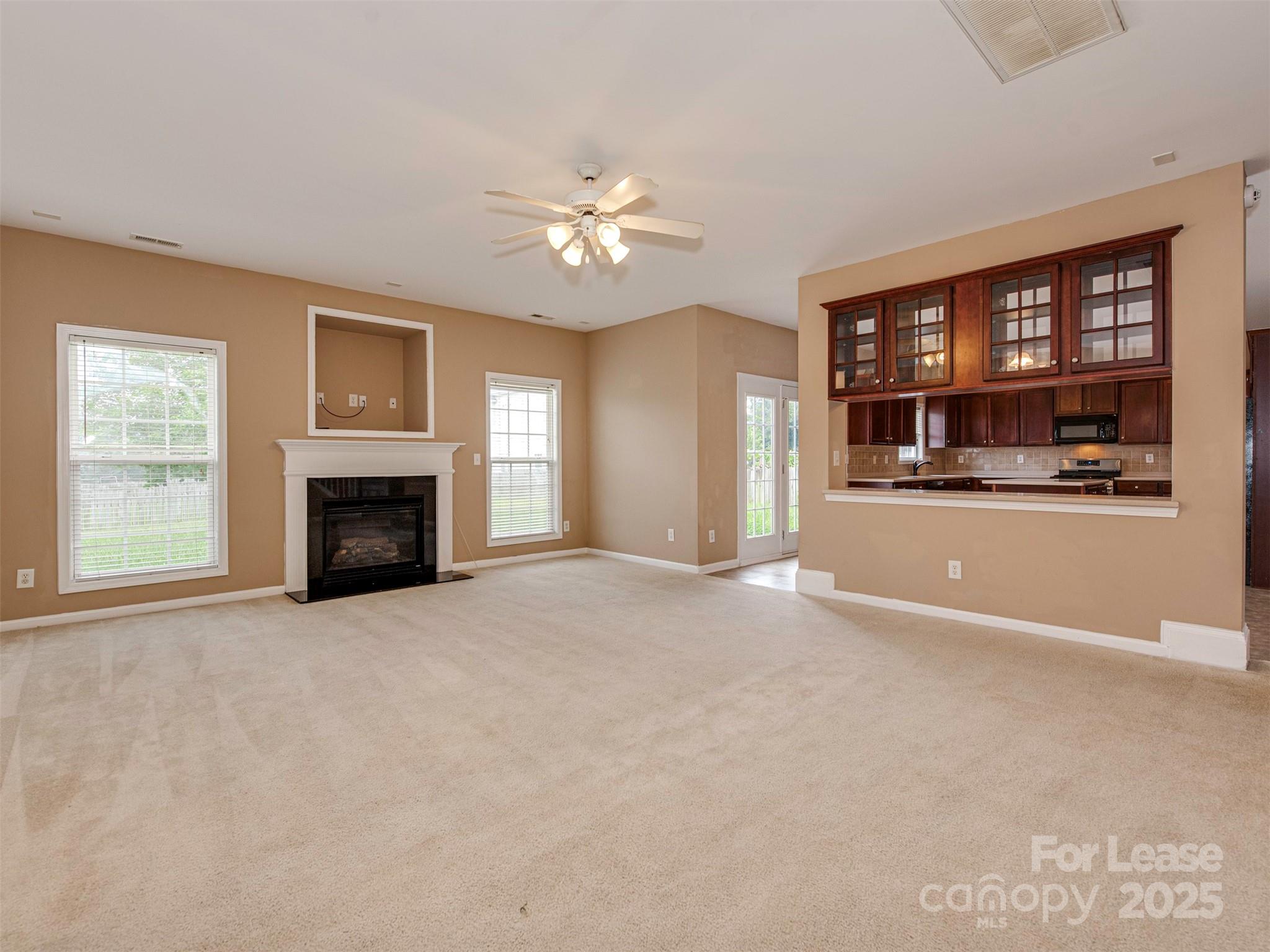 5607 Fulton Ridge Drive Indian Trail, NC 28079 - Photo 10 of 27 a view of an empty room with a fireplace and a window