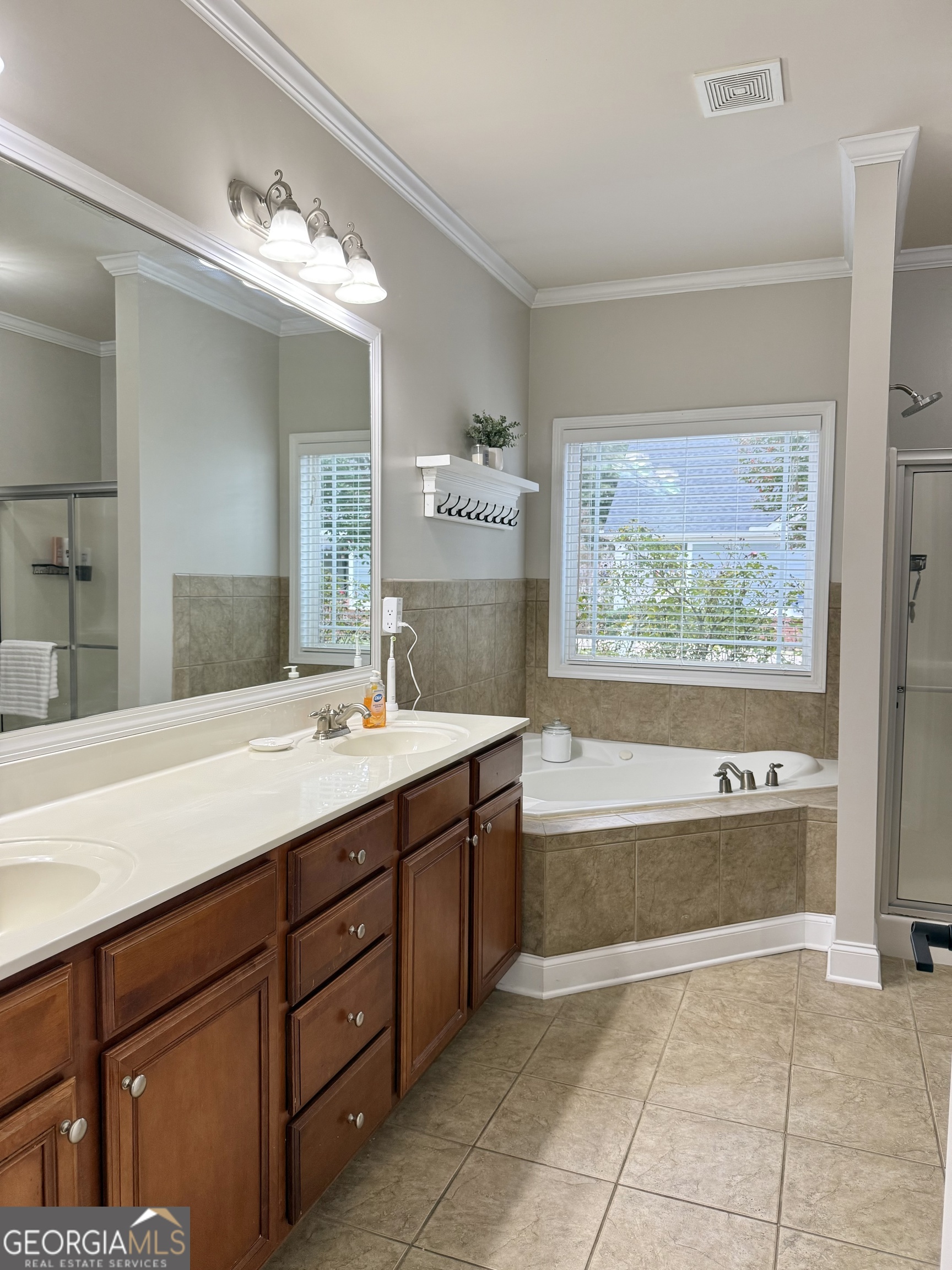 226 Rogue Road Social Circle, GA 30025 - Photo 16 of 23 a spacious bathroom with a tub sink and mirror