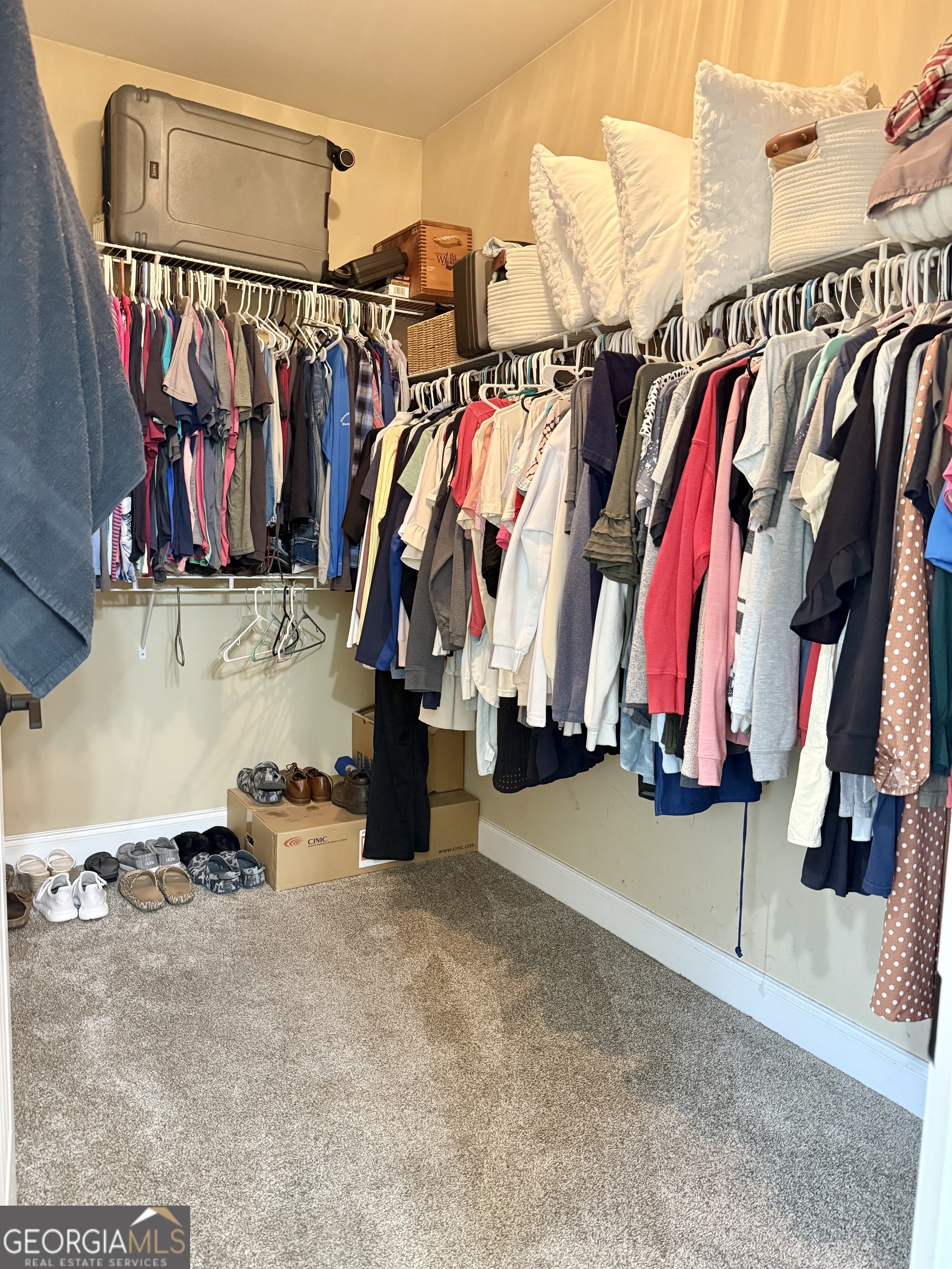226 Rogue Road Social Circle, GA 30025 - Photo 18 of 23 a view of walk in closet with clothes and shoes