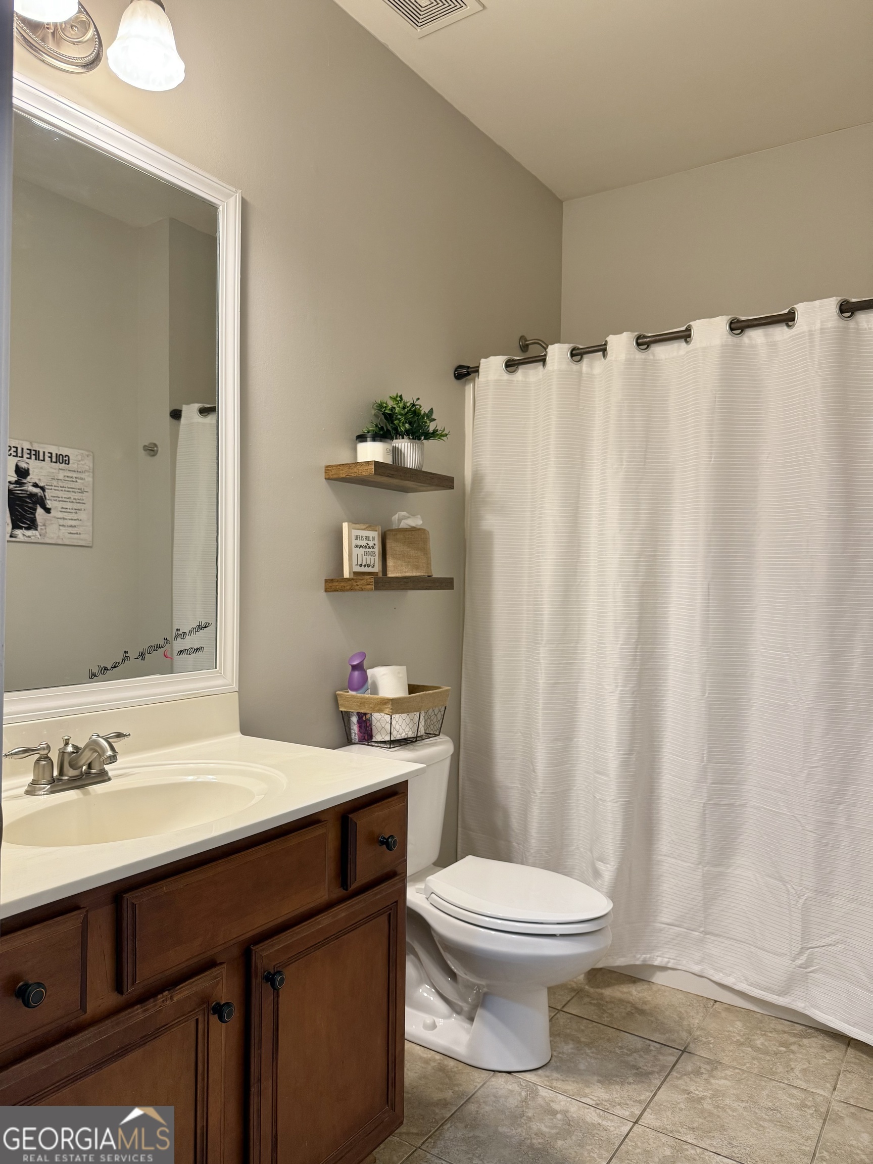 226 Rogue Road Social Circle, GA 30025 - Photo 21 of 23 a bathroom with a sink a toilet and shower curtain