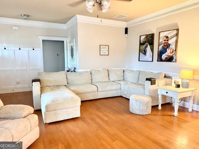 a living room with a fireplace and a flat screen tv