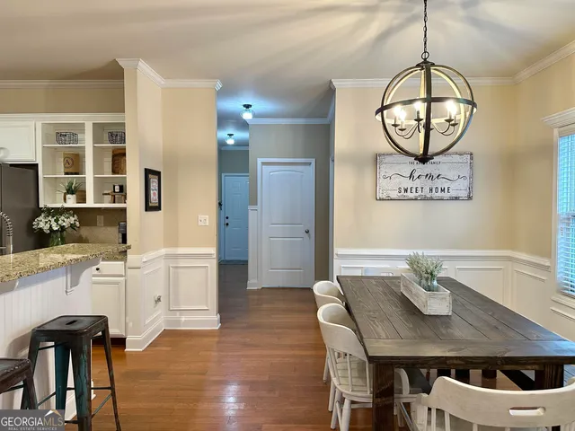 a view of a dining room with furniture wooden floor and chandelier