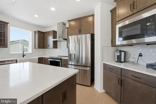 a kitchen with stainless steel appliances a microwave sink and refrigerator