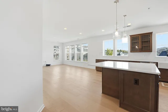 a kitchen with kitchen island a sink appliances and a counter top space