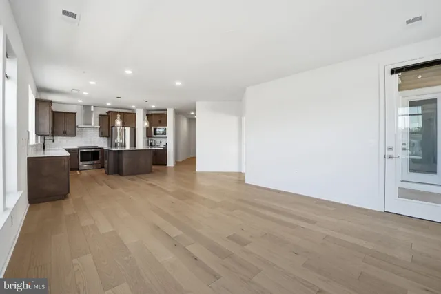a view of kitchen with refrigerator stove microwave and cabinets