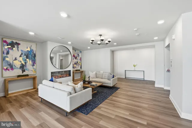 a living room with furniture and a chandelier