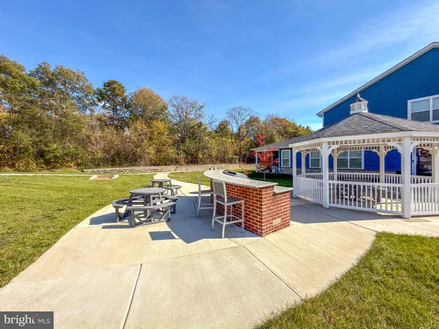 a view of a house with swimming pool and sitting area
