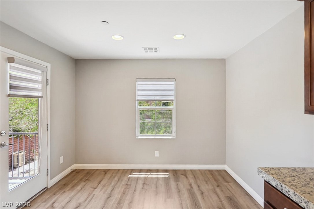 9940 Sable Point Street Las Vegas, NV 89178 - Photo 17 of 40 Unfurnished room with healthy amount of natural light, light wood finished floors, baseboards, and recessed lighting