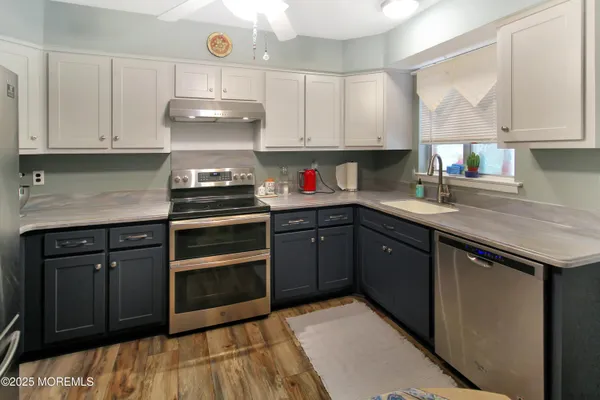 a kitchen with stainless steel appliances granite countertop a sink and cabinets