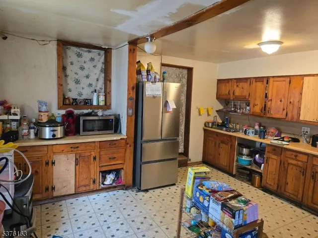 a kitchen with stainless steel appliances granite countertop a refrigerator stove and sink