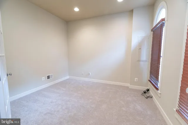 an empty room with windows and entryway