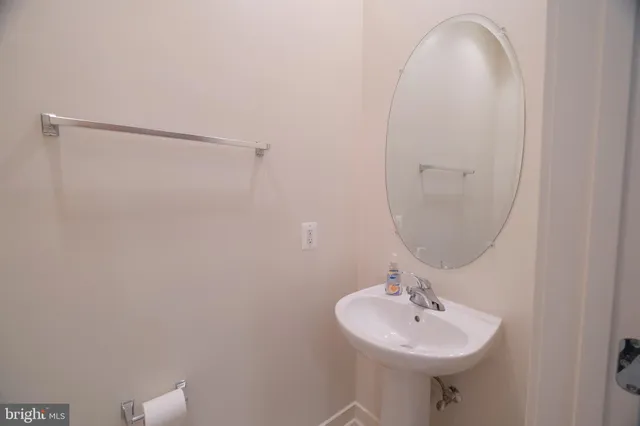 a large kitchen with kitchen island a stove a sink a refrigerator and cabinets