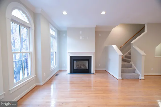 a view of a kitchen with cabinets and wooden floor