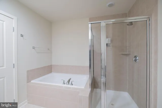 a white bath tub sitting next to a white sink