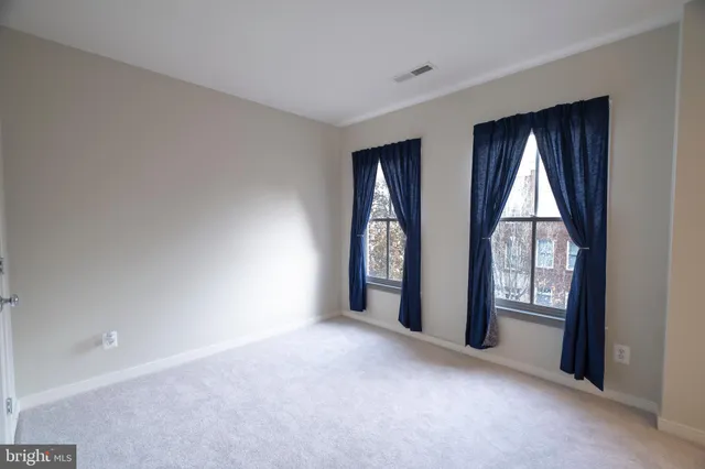 a view of an empty room and glass door