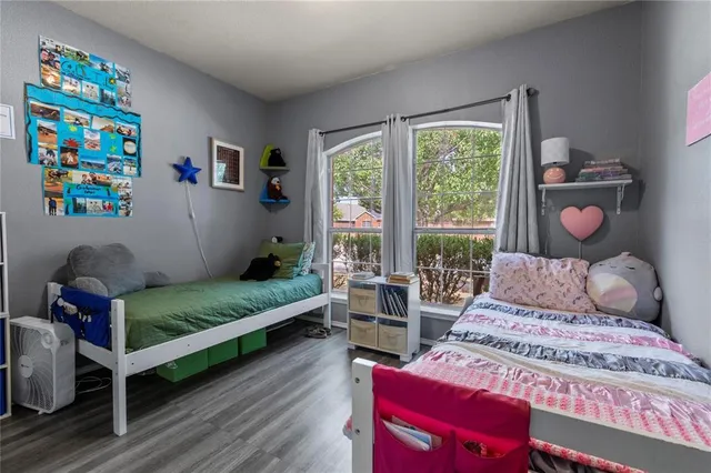 a living room with furniture bookshelf and a window