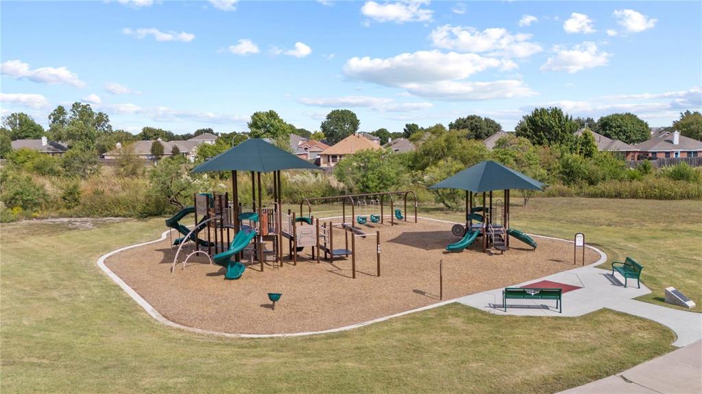 4100 Chisos Rim Trail Fort Worth, TX 76244 - Photo 26 of 30 a roof deck with table and chairs under an umbrella
