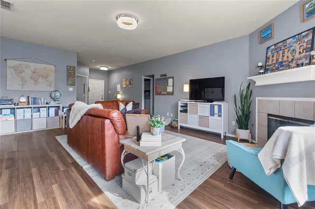 a living room with fireplace furniture and a flat screen tv