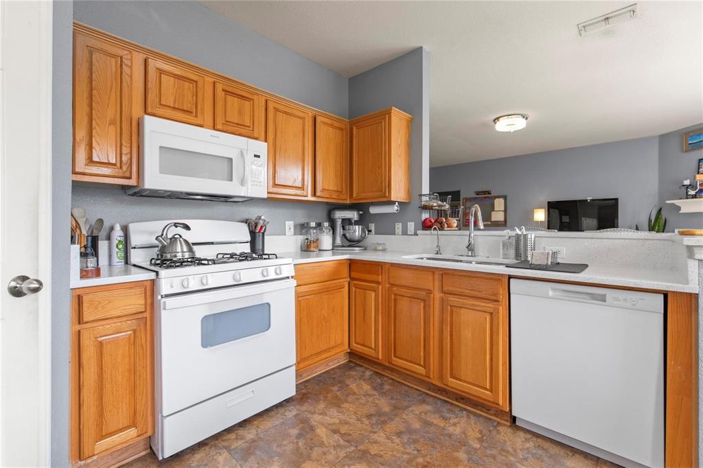 4100 Chisos Rim Trail Fort Worth, TX 76244 - Photo 10 of 30 a kitchen with stainless steel appliances granite countertop a sink stove and refrigerator