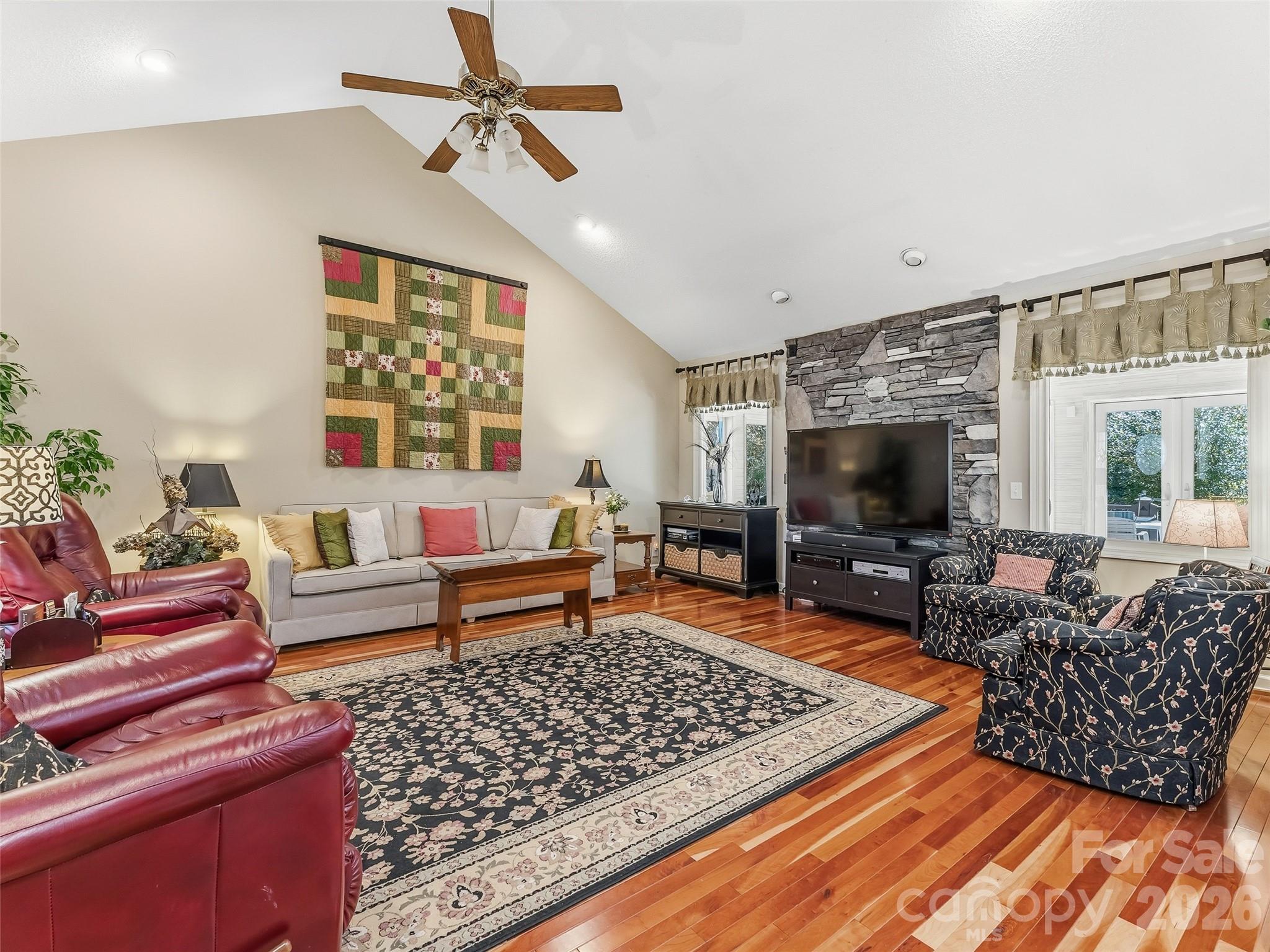 1340 Macedonia Road Saluda, NC 28773 - Photo 11 of 45 a living room with furniture a rug and a flat screen tv