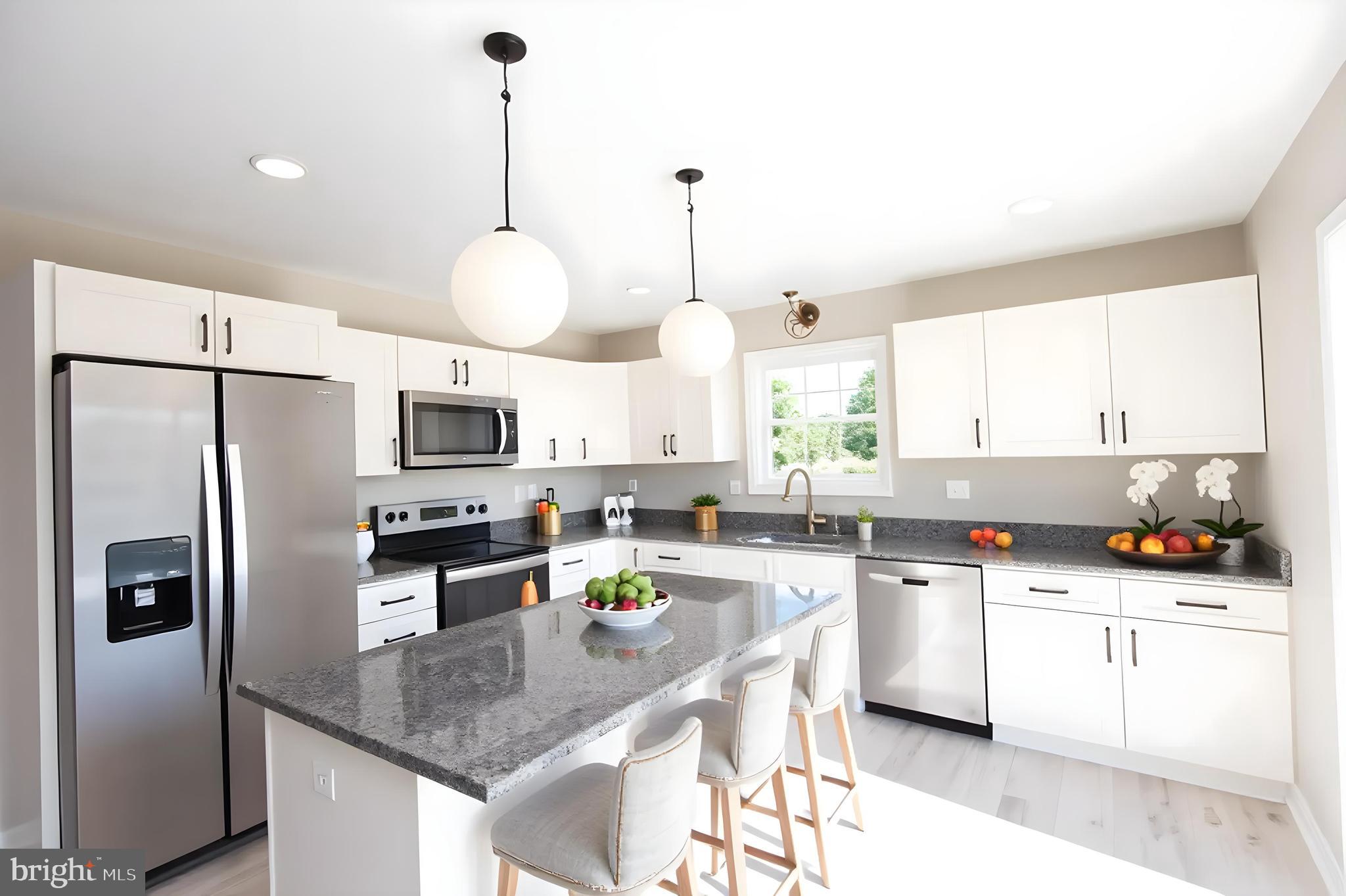 Wrights Rest Road Hurlock, MD 21643 - Photo 5 of 22 a kitchen with stainless steel appliances granite countertop a sink a stove a refrigerator cabinets and a window