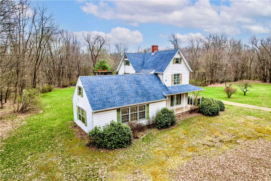 6397 King-Graves Road Fowler, OH 44418 - Photo 6 of 48 View of property exterior featuring a shingled roof, a lawn, and a chimney
