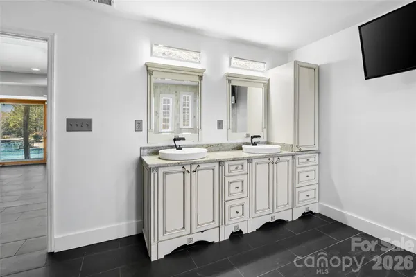 a bathroom with a double vanity sink and mirror