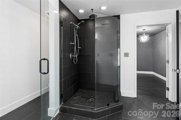 a bathroom with a glass shower door