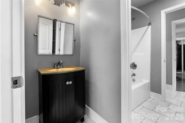 a bathroom with a sink a mirror and a bathtub