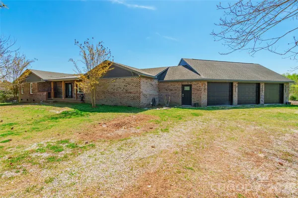 a front view of a house with a garden and yard