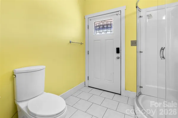 a white toilet sitting next to a bathroom sink