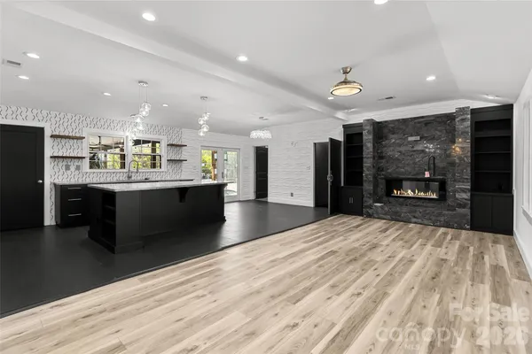 a open kitchen with stainless steel appliances kitchen island a sink stove and a refrigerator