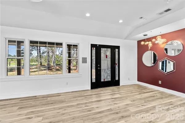 a view of a room with window and wooden floor