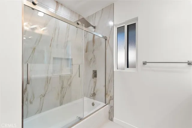 a bathroom with a bathtub and a shower