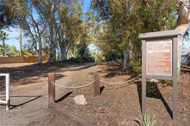 a view of a backyard with chairs and table on the patio