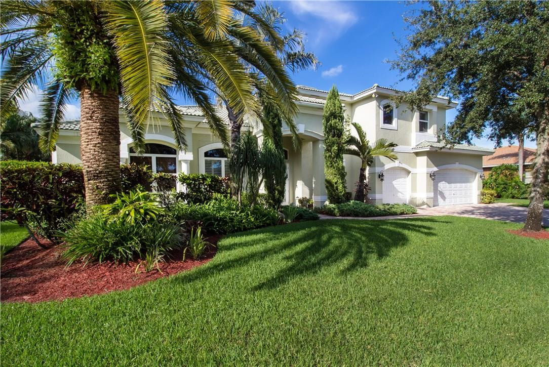 13841 Southwest 44th Street Davie, FL 33330 - Photo 1 of 40 a view of a white house with a big yard and potted plants and palm trees