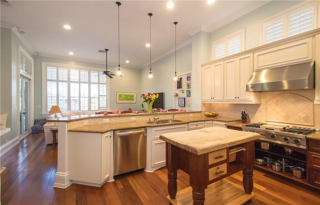13841 Southwest 44th Street Davie, FL 33330 - Photo 13 of 40 a kitchen with a stove a sink a dining table and chairs