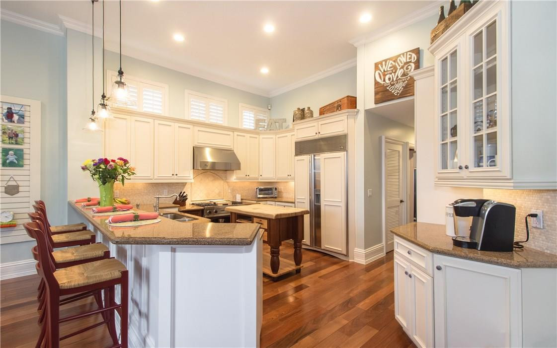 13841 Southwest 44th Street Davie, FL 33330 - Photo 14 of 40 a kitchen with stainless steel appliances granite countertop a stove and a refrigerator