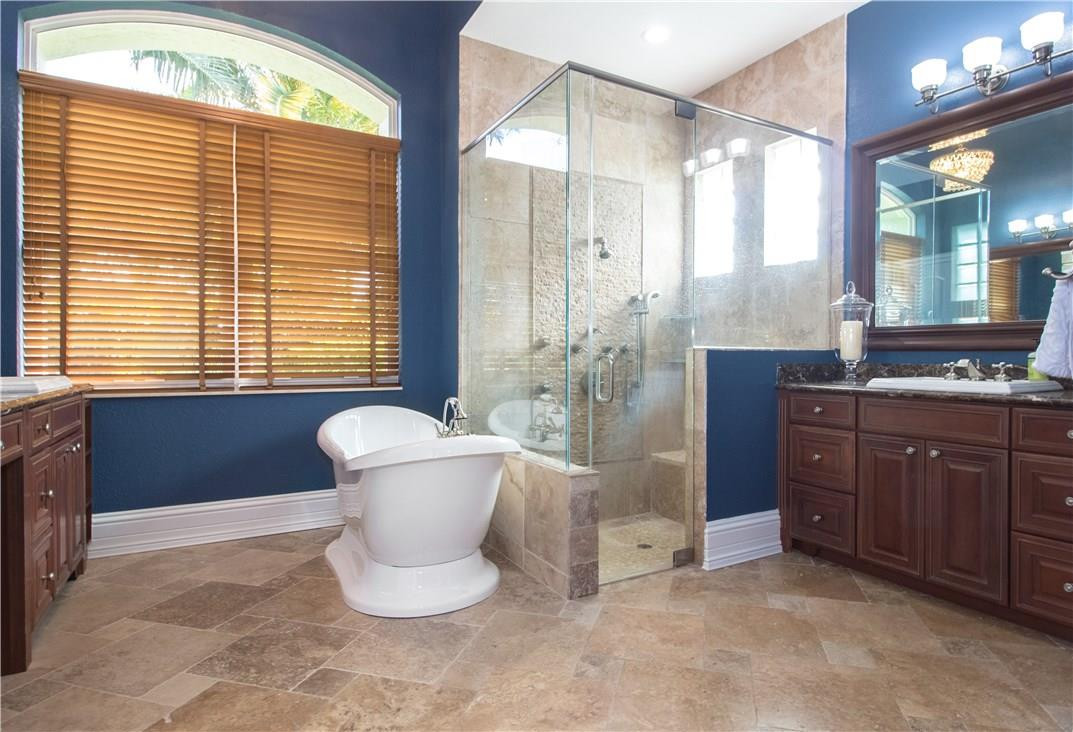 13841 Southwest 44th Street Davie, FL 33330 - Photo 20 of 40 a bathroom with a granite countertop sink toilet and shower